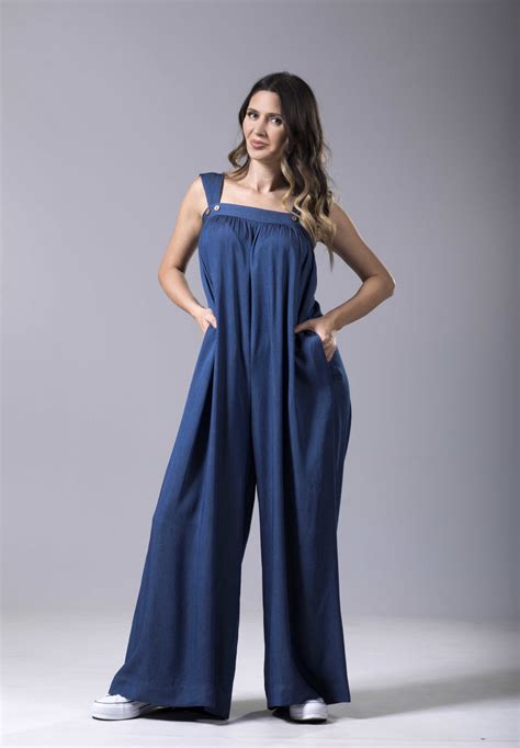 Belted short <b>jumpsuits</b> are designed with bacis collar, button down front, short sleeves, cuffed hem, two chest button-flap <b>pockets</b>, two functional side <b>pockets</b>, and removable belts. . Loose jumpsuit with pockets